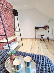 a room with two cups of coffee on a table at L'élémentaire, appartement chic et central in Mulhouse