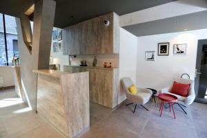 a kitchen with a counter and two chairs at "The Freddie Mercury" Hotel in Montreux
