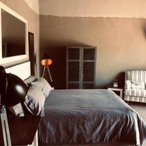 A bed or beds in a room at Simba Safaris African Pride Exotic Lodge