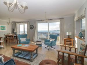 a living room with a table and chairs at Looe Island View in Torpoint