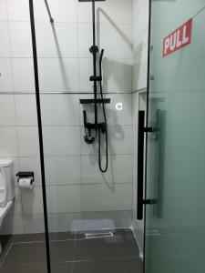 a glass shower door in a bathroom with a toilet at Hotel Thirty Five in Lagos