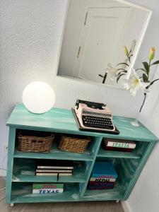 a desk with a keyboard and a mirror at Garay Apartments in Benidorm