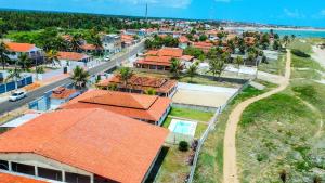 eine Luftansicht einer Stadt mit orangefarbenen Dächern in der Unterkunft Casa Pé Na Areia RN in Touros