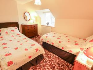 a bedroom with two beds and a sink in it at 22 Beckside in Sudbrooke