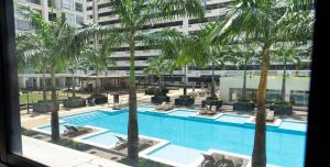 a view of a swimming pool with palm trees at Apartamento 104 Bellini, Puerto Santa Ana, Guayaquil in Guayaquil