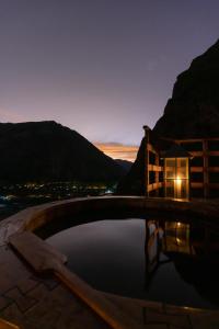 a night view of a swimming pool with a candle in it at Starlodge Adventure Suites in Urubamba +58 photos