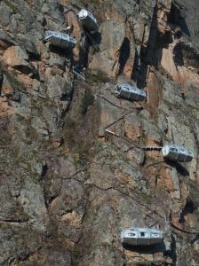 an aerial view of cars parked on the side of a mountain at Starlodge Adventure Suites in Urubamba