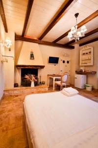 a bedroom with a bed and a table and a fireplace at 1870 Bed & Breakfast in Arpino