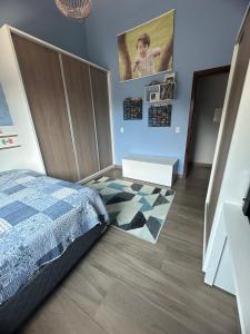 a bedroom with a bed and a rug at Casa de Praia in Imbituba