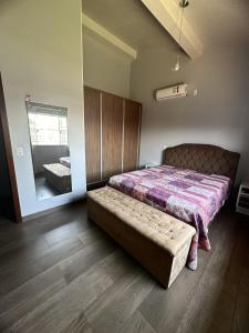 a bedroom with a bed and a large mirror at Casa de Praia in Imbituba