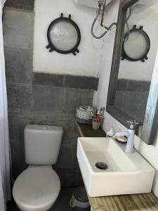 a bathroom with a white toilet and a sink at La Peregrina - Posada in La Pedrera