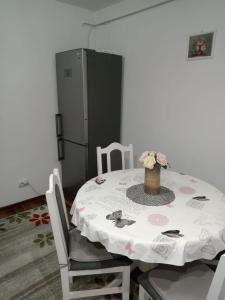 a kitchen with a table and a refrigerator at Penti Apartament in Suceava