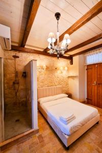 a bedroom with a large bed and a chandelier at 1870 Bed & Breakfast in Arpino