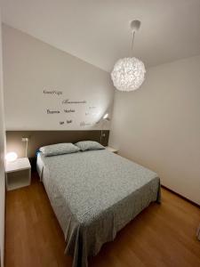 a bedroom with a bed and a pendant light at Case Vacanze Berton Tirano in Tirano