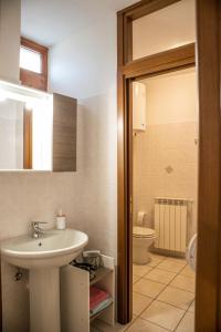 a bathroom with a sink and a toilet at Case Vacanze Berton Tirano in Tirano