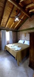 a bedroom with a large bed in a room at Cabañas & Suites "No es Fácil" in Villa Yacanto