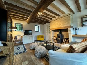 a living room with a couch and a fireplace at La Maison Cornière in Biéville-en-Auge