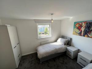 a small bedroom with a bed and a window at Luxury home in rugby ready 4U 
