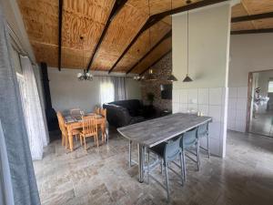 a dining room and living room with a table and chairs at Stay@51 Botha in Oudtshoorn