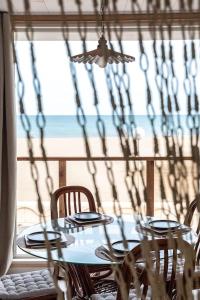 a table and chairs with a view of the beach at La vie en Rose in Narbonne