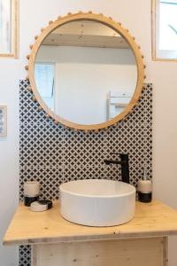 a bathroom with a white sink and a mirror at La vie en Rose in Narbonne