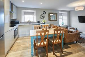 a kitchen and dining room with a table and chairs at Host & Stay - Fenwick Village Hall in Fenwick