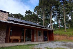 a house with solar panels on top of it at Pousada Vale do Tigre in Rio Rufino