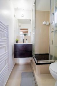 a bathroom with a glass shower and a toilet at Skyview - Triel sur Seine in Triel-sur-Seine