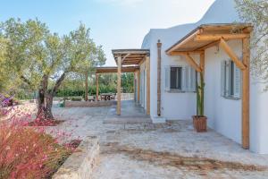 a view of a house with a pergola at Villa Del Capitolo Con Trullo By Raro Villas in Carovigno