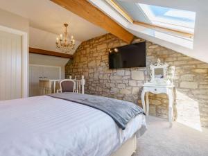 a bedroom with a bed and a stone wall at 3 Bed in Amble 83995 in Amble