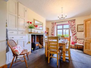 a dining room with a table and chairs at 3 Bed in Eskdale SZ072 in Santon Bridge