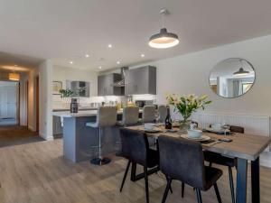 a dining room and kitchen with a table and chairs at 2 Bed in Usk 83993 in Trostrey