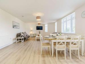 a dining room and living room with a table and chairs at 3 Bed in Wooler 83975 in Wooler