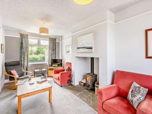 a living room with red furniture and a fireplace at 3 Bed in Borrowdale SZ148 in Grange