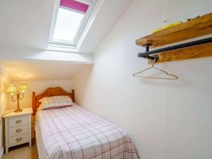 a small bedroom with a bed and a window at 3 Bed in Bassenthwaite 84024 in Bassenthwaite