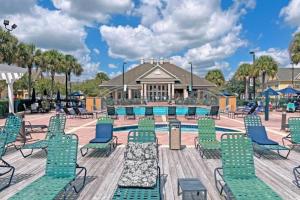 a pool with chaise lounge chairs and a resort at Your home 5 * near Disney in Kissimmee