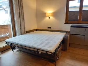 A bed or beds in a room at Gästehaus Toferer