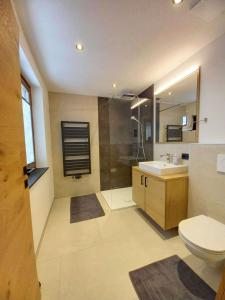 a bathroom with a toilet and a sink and a shower at Gästehaus Toferer in Grossarl