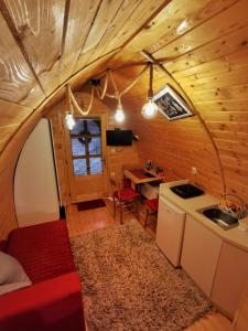 a kitchen and dining area of a tiny house at Vila Jelena - BUNGALOV in Crni Vrh