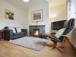 a living room with a couch and a fireplace at 2 Bed in Borrowdale SZ068 in Rosthwaite