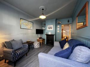 a living room with a couch and a chair at Ivy Cottage in Brading