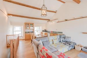 a living room with a couch and a kitchen at 2 Bed in Ravenglass SZ409 in Ravenglass
