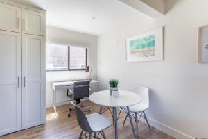 a white room with a table and chairs and a desk at Redondo Beach 1br nr water restaurants shops LAX-1170 in Redondo Beach