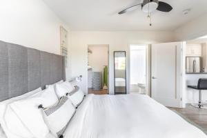 a bedroom with a large white bed with a ceiling fan at Redondo Beach 1br nr water restaurants shops LAX-1170 in Redondo Beach