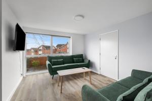 a living room with a couch and a table at Spacious Free Parking Contractors and Corporate in Exeter