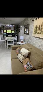 a living room with a couch with pillows on it at bangalô Lucena in Lucena