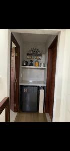 a kitchen with a stove and a microwave at bangalô Lucena in Lucena