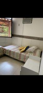 a room with a bed with two bananas on it at bangalô Lucena in Lucena