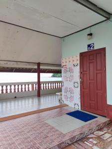 桐艾的住宿－Chuttong resort，一间空房间,设有红色的门和一个阳台