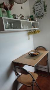 a desk with a chair and a table and shelves at La Toscana - Actum in San Miguel de Tucumán
